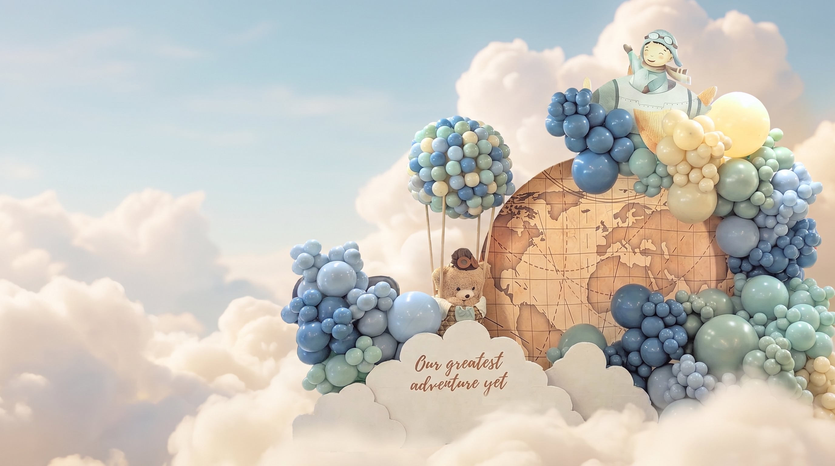 A dreamy blue and cream balloon installation with a globe backdrop surrounded by clouds.